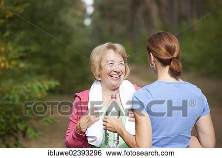 Women taking a break while doing sports outdoors View Large Photo Image Stock Photograph - Women taking a break while doing sports outdoors. Fotosearch