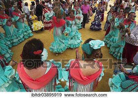 "Women wearing gypsy dresses perform traditional Andalusian dances at the Feria del Caballo, Jerez de la Frontera, Cadiz province, Andalusia, Spain, Europe" View Large Photo Image Stock Photo - "Women wearing gypsy dresses perform traditional Andalusian dances at the Feria del Caballo, Jerez de la Frontera, Cadiz province, Andalusia, Spain, Europe". Fotosearch