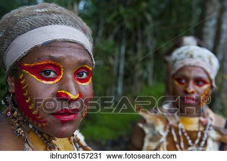 "Women with colourful face paint are celebrating at the traditional Sing Sing gathering in the highlands, Paya, Papua New Guinea, Oceania" View Large Photo Image Stock Image - "Women with colourful face paint are celebrating at the traditional Sing Sing gathering in the highlands, Paya, Papua New Guinea, Oceania". Fotosearch
