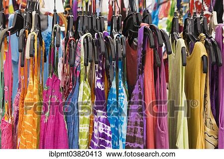 Stock Image - "Women's cotton dresses for sale on a clothes rack at an outdoor market, Byward Market, Ottawa, Ontario, Canada, North America". Fotosearch