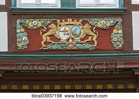 "Wood carvings on the framework of the half-timbered house of the former inn """"Zum Goldenen Lowen"""", Butzbach, Hesse, Germany, Europe" View Large Photo Image Stock Photo - "Wood carvings on the framework of the half-timbered house of the former inn """"Zum Goldenen Lowen"""", Butzbach, Hesse, Germany, Europe". Fotosearch