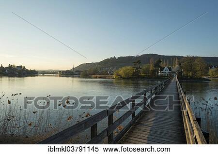 Stock Photography - "Wooden bridge crossing the Rhine River to the monastery island of Werd, Stein am Rhein, Canton of Schaffhausen, Switzerland, Europe". Fotosearch