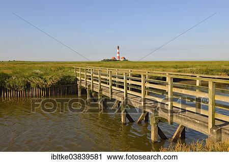 "Wooden bridge, Westerheversand Lighthouse at the back, Westerhever, Eiderstedt, North Frisia, Schleswig-Holstein, Germany, Europe" View Large Photo Image Stock Image - "Wooden bridge, Westerheversand Lighthouse at the back, Westerhever, Eiderstedt, North Frisia, Schleswig-Holstein, Germany, Europe". Fotosearch