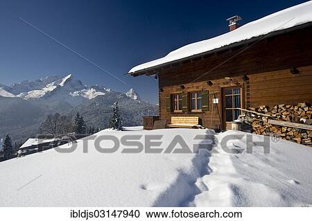 "Wooden house on a snow-covered hill, Mt Alpspitze and Mt Zugspitze at back, Eckbauer, Garmisch-Partenkirchen, Upper Bavaria, Bavaria, Germany, Europe" View Large Photo Image Stock Image - "Wooden house on a snow-covered hill, Mt Alpspitze and Mt Zugspitze at back, Eckbauer, Garmisch-Partenkirchen, Upper Bavaria, Bavaria, Germany, Europe". Fotosearch