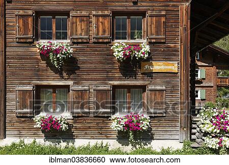 Stock Image - "Wooden house with a sign """"Ferienwohnung"""", German for """"holiday apartment"""", Gaschurn, Montafon, Vorarlberg, Austria, Europe". Fotosearch