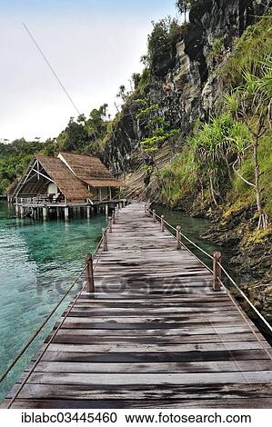 "Wooden pier and water bungalows in a holiday resort, Batbitim Island, Raja-Ampat, West Papua, Indonesia, Asia" View Large Photo Image Stock Image - "Wooden pier and water bungalows in a holiday resort, Batbitim Island, Raja-Ampat, West Papua, Indonesia, Asia". Fotosearch