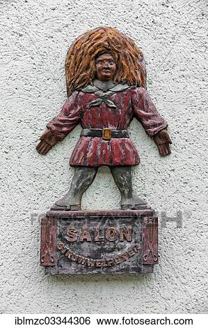 "Wooden relief, Struwwelpeter figure on a wall in front of a hair salon, Malchow, Mecklenburg-Western Pomerania, Germany, Europe" View Large Photo Image Stock Photograph - "Wooden relief, Struwwelpeter figure on a wall in front of a hair salon, Malchow, Mecklenburg-Western Pomerania, Germany, Europe". Fotosearch