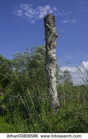 Stock Photograph - "Wooden sculpture, Mazurski Eden or Masurian Garden of Eden, reconstruction of Galindian culture, Gmina Ruciane-Nida, Warmian-Masurian Voivodeship, Poland, Europe". Fotosearch