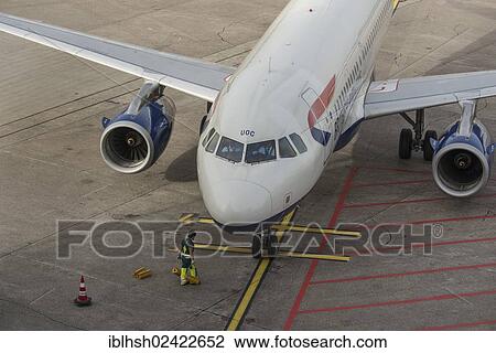 Worker attaching brake pads to a parked aircraft, Duesseldorf International Airport, North Rhine-Westphalia, Germany, Europe View Large Photo Image Stock Image - Worker attaching brake pads to a parked aircraft, Duesseldorf International Airport, North Rhine-Westphalia, Germany, Europe. Fotosearch