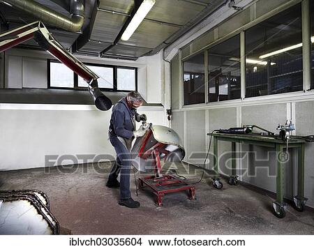 "Worker grinding a fender in a workshop, Kundl, Kufstein District, North Tirol, Tirol, Austria, Europe" View Large Photo Image Picture - "Worker grinding a fender in a workshop, Kundl, Kufstein District, North Tirol, Tirol, Austria, Europe". Fotosearch