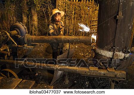 "Worker in a foundry, Shan State, Myanmar, Burma, Asia" View Large Photo Image Stock Photo - "Worker in a foundry, Shan State, Myanmar, Burma, Asia". Fotosearch