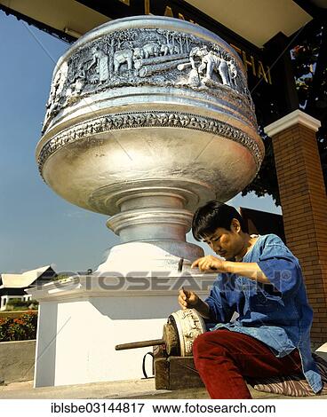Stock Photo - "Worker in a silver factory peening a bowl, Chiang Mai, Northern Thailand, Thailand, Asia". Fotosearch
