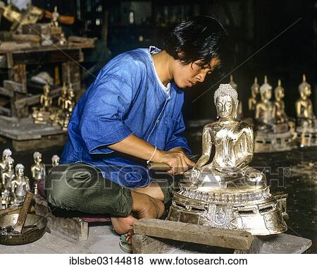 "Worker in a silver factory working on a silver Buddha statue, Chiang Mai, Northern Thailand, Thailand, Asia" View Large Photo Image Stock Photo - "Worker in a silver factory working on a silver Buddha statue, Chiang Mai, Northern Thailand, Thailand, Asia". Fotosearch