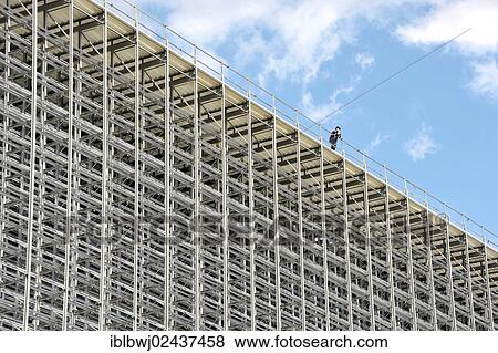"Worker on the roof of a high bay warehouse during construction, Hilpoltstein, Bavaria, Germany, Europe" View Large Photo Image Stock Photo - "Worker on the roof of a high bay warehouse during construction, Hilpoltstein, Bavaria, Germany, Europe". Fotosearch