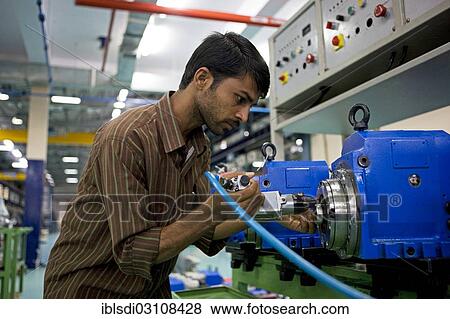 "Worker on the shop floor of a supplier for the German engineering company Mao Deckel, Bangalore, Karnataka, India, Asia" View Large Photo Image Stock Photo - "Worker on the shop floor of a supplier for the German engineering company Mao Deckel, Bangalore, Karnataka, India, Asia". Fotosearch