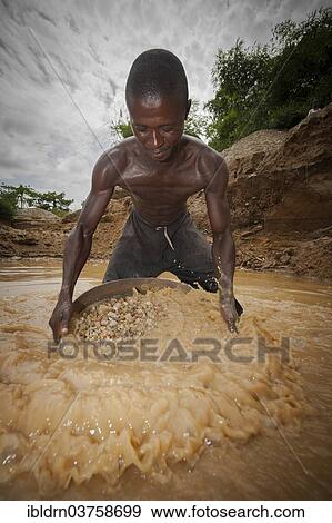 "Worker washing gravel at a diamond mine, Kenema, Eastern Province, Sierra Leone, Africa" View Large Photo Image Stock Photo - "Worker washing gravel at a diamond mine, Kenema, Eastern Province, Sierra Leone, Africa". Fotosearch