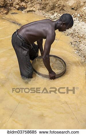 "Worker washing gravel at a diamond mine, Kenema, Eastern Province, Sierra Leone, Africa" View Large Photo Image Stock Photography - "Worker washing gravel at a diamond mine, Kenema, Eastern Province, Sierra Leone, Africa". Fotosearch