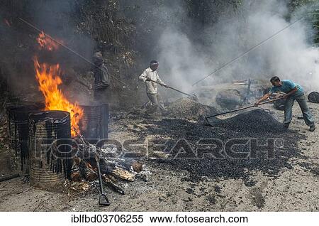 Stock Photography - "Workers applying hot asphalt to a road at a construction site, Shimla, Himachal Pradesh, India, Asia". Fotosearch
