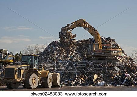 Stock Image - "Workers pile debris from Hurricane Sandy in a parking lot next to the beach on Staten Island, New York City, New York, United States, North America". Fotosearch