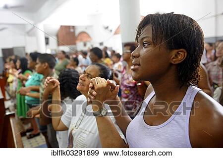 "Worshippers holding each other's hands and praying, Catholic mass in a slum or favela, Jacarezinho favela, Rio de Janeiro, Rio de Janeiro State, Brazil, South America" View Large Photo Image Stock Photo - "Worshippers holding each other's hands and praying, Catholic mass in a slum or favela, Jacarezinho favela, Rio de Janeiro, Rio de Janeiro State, Brazil, South America". Fotosearch