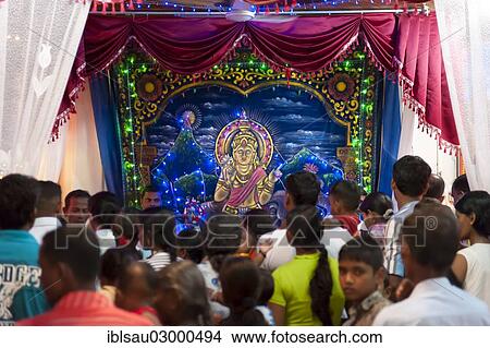 Picture - "Worshipping Hindus, Hindu shrine with an image of the deity Saman in the Buddhist Mahiyangana Temple, Mahiyangana, Sri Lanka, Asia". Fotosearch
