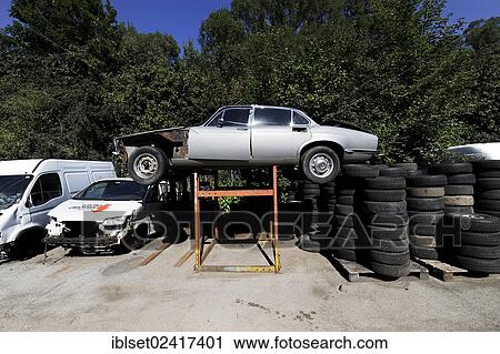 Wrecked cars and tyres in a junkyard, car recycling View Large Photo Image Stock Image - Wrecked cars and tyres in a junkyard, car recycling. Fotosearch