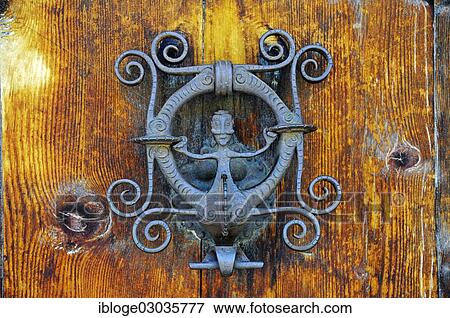 "Wrought-iron door knocker with a figure, Guarda, Unterengadin, Engadin, Canton of Graubunden, Switzerland, Europe" View Large Photo Image Stock Photo - "Wrought-iron door knocker with a figure, Guarda, Unterengadin, Engadin, Canton of Graubunden, Switzerland, Europe". Fotosearch