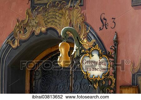 "Wrought iron hanging shop sign of the Geigenbaumuseum violin making museum, Mittenwald, Werdenfelser Land, Upper Bavaria, Bavaria, Germany, Europe" View Large Photo Image Stock Image - "Wrought iron hanging shop sign of the Geigenbaumuseum violin making museum, Mittenwald, Werdenfelser Land, Upper Bavaria, Bavaria, Germany, Europe". Fotosearch