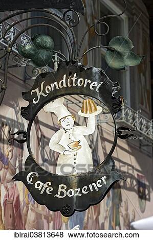 "Wrought iron hanging shop sign of the Konditorei Cafe Bozener pastry cafe, Mittenwald, Werdenfelser Land, Upper Bavaria, Bavaria, Germany, Europe" View Large Photo Image Stock Photo - "Wrought iron hanging shop sign of the Konditorei Cafe Bozener pastry cafe, Mittenwald, Werdenfelser Land, Upper Bavaria, Bavaria, Germany, Europe". Fotosearch