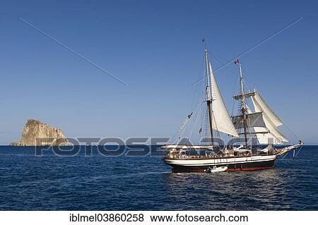 "Yacht sailing off Isola Dattilo, volcanic island, Tyrrhenian Sea, Aeolian Islands, Sicily, Italy, Europe" View Large Photo Image Stock Photo - "Yacht sailing off Isola Dattilo, volcanic island, Tyrrhenian Sea, Aeolian Islands, Sicily, Italy, Europe". Fotosearch