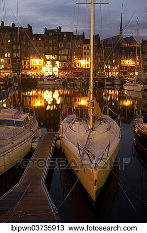 Stock Image - "Yachts in the harbour at night, Honfleur, Normandy, France, Europe". Fotosearch