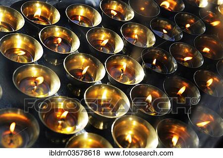 "Yak butter lamps burning at a shrine en route to the monastery and temple complex of Taktshang-Lhakang, also known as the """"Tiger's Lair"""", Paro valley, Paro district, Bhutan, Asia" View Large Photo Image Stock Photo - "Yak butter lamps burning at a shrine en route to the monastery and temple complex of Taktshang-Lhakang, also known as the """"Tiger's Lair"""", Paro valley, Paro district, Bhutan, Asia". Fotosearch