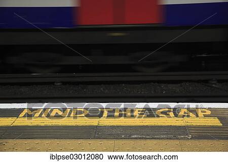 "Yellow marking MIND THE GAP on the floor of a station of the London Underground, train departing, London, London region, England, United Kingdom, Europe" View Large Photo Image Stock Image - "Yellow marking MIND THE GAP on the floor of a station of the London Underground, train departing, London, London region, England, United Kingdom, Europe". Fotosearch