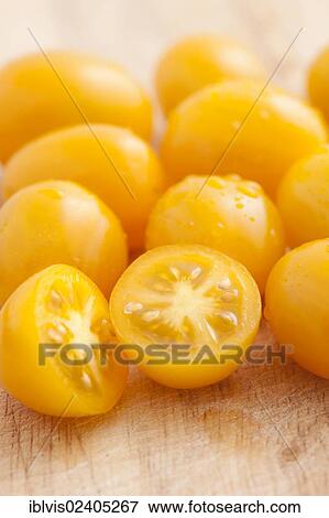 Yellow plum tomatoes on a cutting board View Large Photo Image Stock Photo - Yellow plum tomatoes on a cutting board. Fotosearch