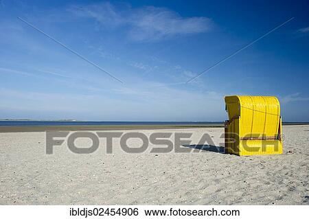 Stock Photograph - "Yellow roofed wicker beach chairs on the beach near Utersum, Foehr Island, North Frisian Islands, Schleswig-Holstein, Germany, Europe". Fotosearch