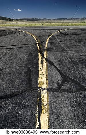 Stock Image - "Yellow worn tarmac markings at an airport, Ely, Nevada, United States, North America". Fotosearch