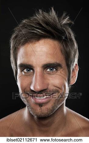Stock Image - "Young, attractive man with a friendly smile, portrait". Fotosearch