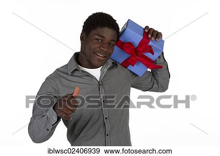 Young black man holding a present View Large Photo Image Stock Photo - Young black man holding a present. Fotosearch