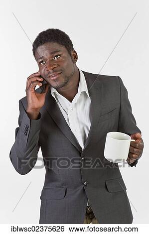 Young black man using a mobile phone View Large Photo Image Stock Photograph - Young black man using a mobile phone. Fotosearch