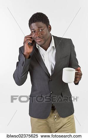 Stock Photography - Young black man using a mobile phone. Fotosearch