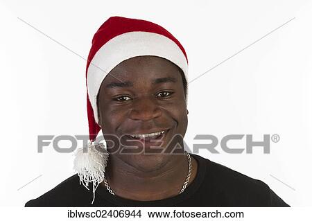 "Young black man with a Santa hat, portrait" View Large Photo Image Picture - "Young black man with a Santa hat, portrait". Fotosearch