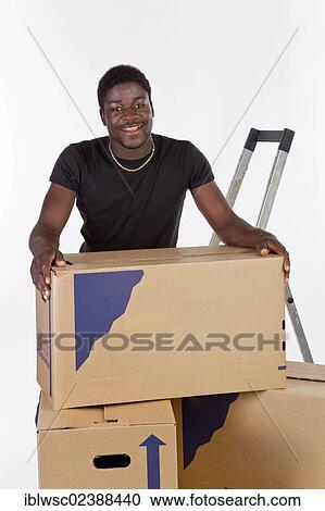 Young black man with moving boxes View Large Photo Image Stock Image - Young black man with moving boxes. Fotosearch