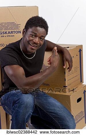 Young black man with moving boxes View Large Photo Image Stock Image - Young black man with moving boxes. Fotosearch