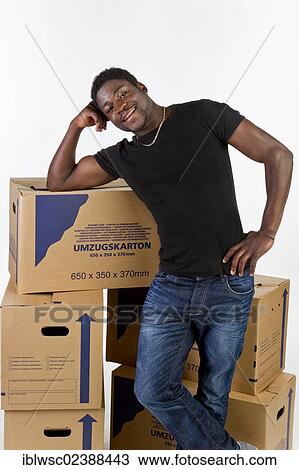 Young black man with moving boxes View Large Photo Image Stock Image - Young black man with moving boxes. Fotosearch