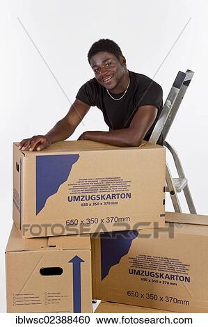 Young black man with moving boxes View Large Photo Image Stock Image - Young black man with moving boxes. Fotosearch