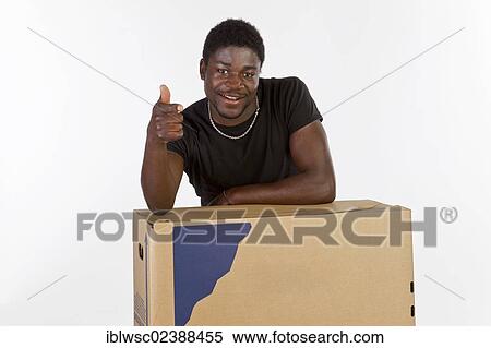 Stock Photography - Young black man with moving boxes. Fotosearch