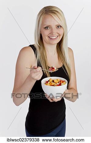Young blonde woman holding a bowl of muesli View Large Photo Image Stock Photo - Young blonde woman holding a bowl of muesli. Fotosearch