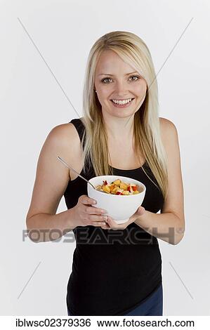 Young blonde woman holding a bowl of muesli View Large Photo Image Stock Photograph - Young blonde woman holding a bowl of muesli. Fotosearch
