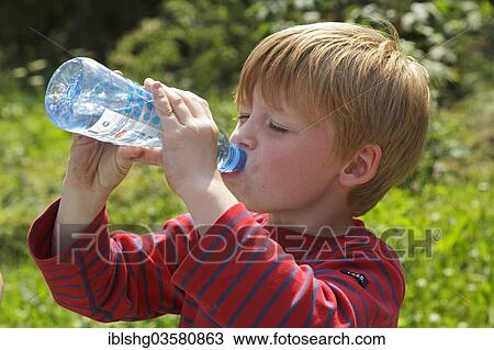 "Young boy drinking water, Germany, Europe" View Large Photo Image Stock Image - "Young boy drinking water, Germany, Europe". Fotosearch