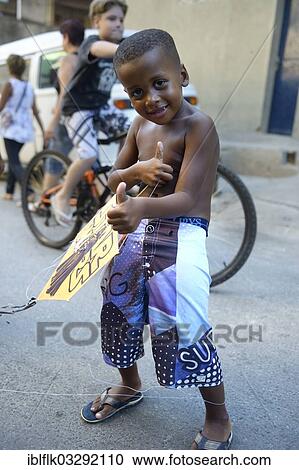 "Young boy holding a kite in a slum or favela, Jacarezinho favela, Rio de Janeiro, Rio de Janeiro State, Brazil, South America" View Large Photo Image Stock Image - "Young boy holding a kite in a slum or favela, Jacarezinho favela, Rio de Janeiro, Rio de Janeiro State, Brazil, South America". Fotosearch